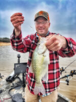 Capt. Brannon Kirby, a guide with Barton Outfitters, shows off a 13-inch white crappie – basically an “average” fish on Mississippi’s Enid Lake. (Photo: Richard Simms)