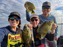 Big rock bass provided great fun on Lake Bemidji for author Tim Huffman (center) and his partners, Jennifer Pudenz and Nick Linder. Huffman said the fish were eight to 11 inches long and fierce fighters.
