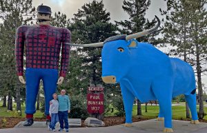 Author Tim Huffman and his wife, Jeanne, pose with Paul Bunyan and Babe the Blue Ox at the Bemidji Vistors Center. The statues are a symbol of Minnesota’s rich logging heritage.