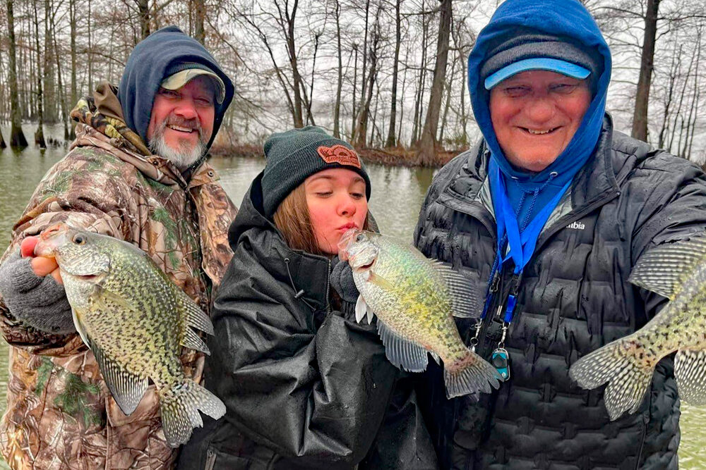 Perhaps in honor of Valentine’s Day, Reel Deal columnist Lindsey Lucas could resist giving her crappie a little kiss. Fishing with her Dad, Kody (left), and CrappieNOW publisher Dan Dannenmueller, they found some cold winter crappie.