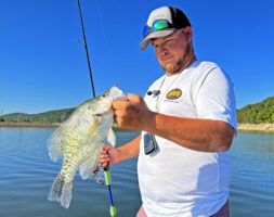 Guide Jordan Isaacs holds a good crappie taken by casting from Bull Shoals Lake in Missouri, only a short drive from Branson. (Photo: Tim Huffman)