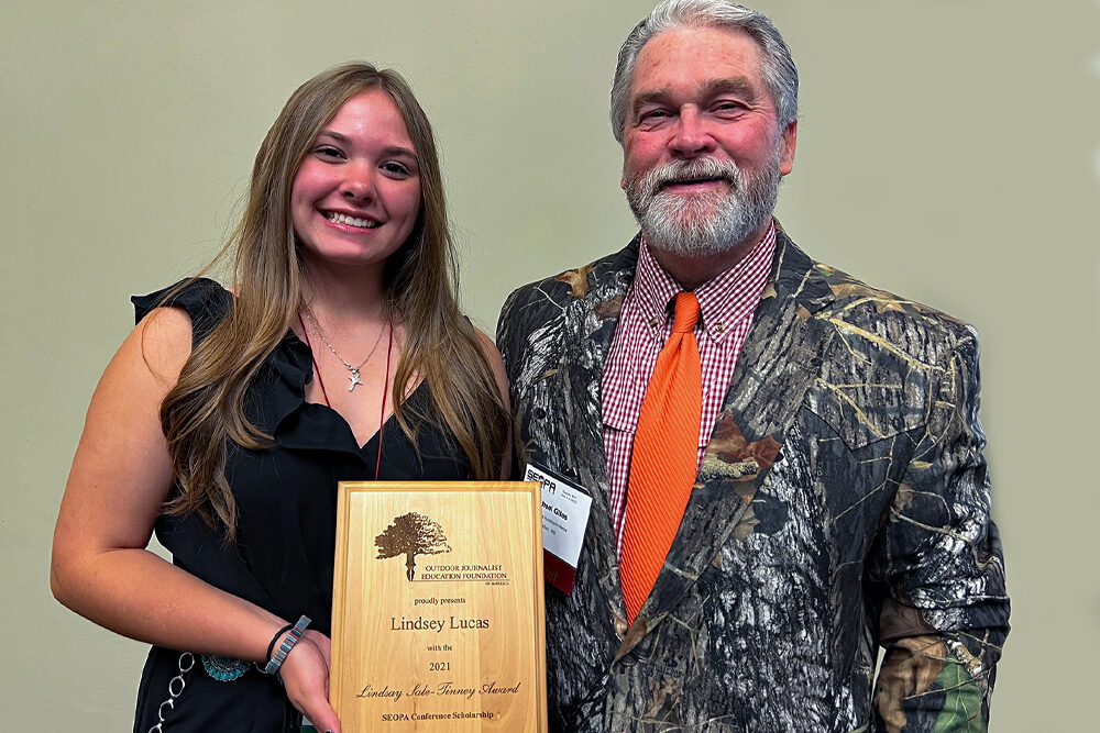CrappieNOW columnist Lindsey Lucas receives a scholarship award from Mike Giles, President of the Southern Outdoor Press Association.