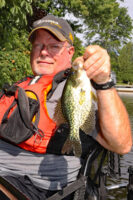 Dave Ohmer with his first crappie of the day on Sugar Lake. This size is abundant in small natural lakes with native minnow/shiner forage base. (Photo: Darl Black)