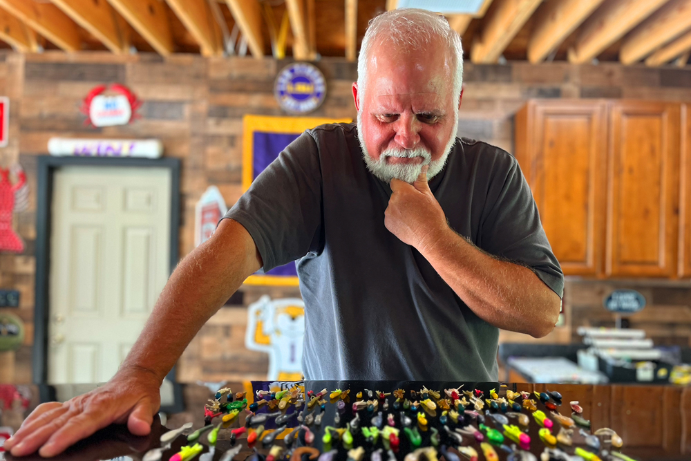 Jim Bates bought over $1,000 worth of lures when he got into crappie fishing. Now he just has to decide which one to use on his next crappie trip. (Photo: Keith Lusher)