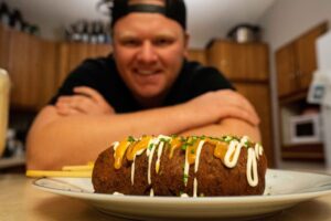 Ryan Pinkalla of The Crappie Chronicles shows off a crappie corn dog. You can find the recipe to try it yourself from Season 2. (Photo courtesy Adam Bartusek)
