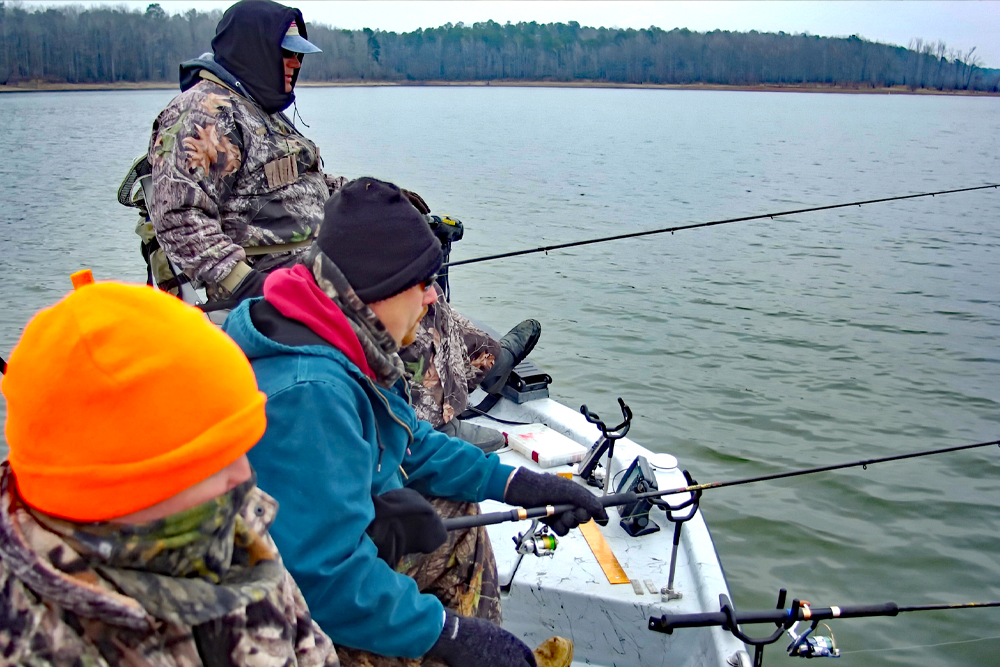 Bundled up against winter’s cold, the author’s fishing party enjoys the season’s peace while waiting for a bite on Arkansas’ Lake Greeson. (Photo: Keith Sutton)