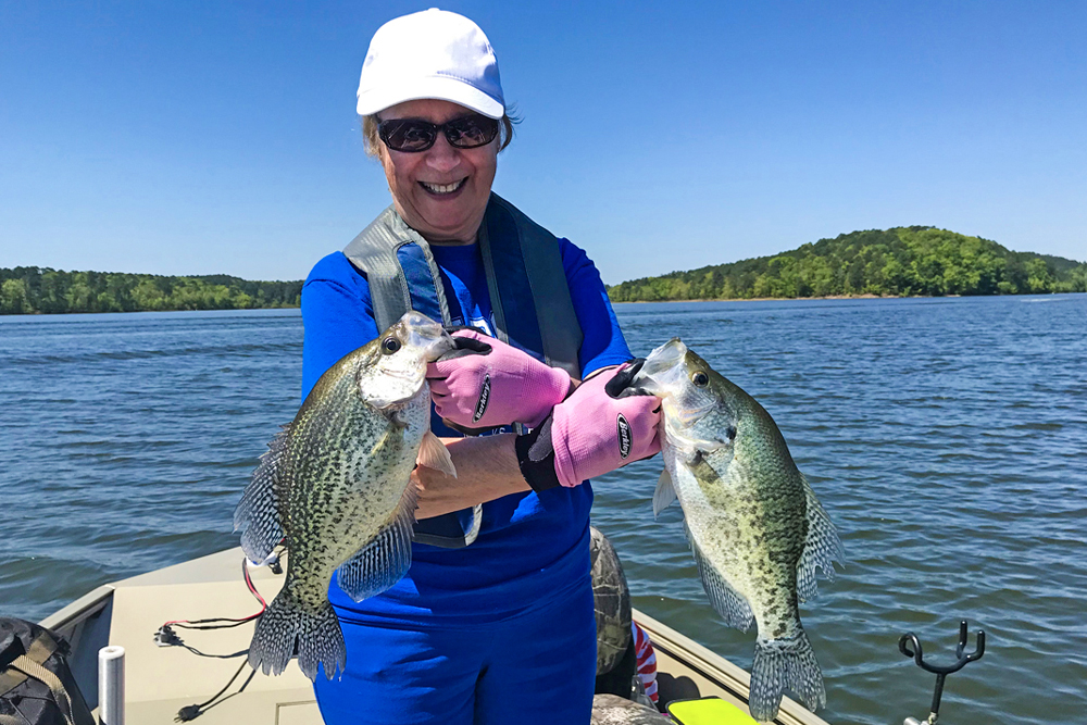 Jeanne Huffman shows off a beautiful brace of crappie, including a black and crappie taken while pulling crankbaits in Arkansas. (Photo: Tim Huffman)