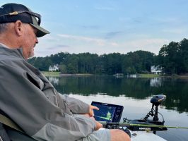 Capt. Doug Nelms points to some of the submerged structure that makes Lake Oconee prime for crappie fishing. (Photo by Anietra Hamper)