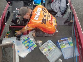 A wide range of bait sizes, colors and patterns are a necessity for successful crappie anglers. Here, Steve Brown is planning on how to entice a postspawn female into biting a jig. (photo Richard Hines)