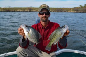 Guide Joe Bragg catches both big black crappies (left) and white crappies when he trolls crankbaits on Kansas reservoirs. (Photo: Brent Frazee) | Break out the Bandits for Crappie