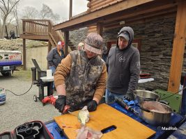 Another first for this academy was the addition of workstations—some in preparation for the fish fry. Here, instructor Ernest Strouse guides B’n’M Fishing Jr. ProStaffer and academy attendee Courtney Sanders in harvesting the meat from her catch. Other stations included boater safety, knot tying, rod and reel rigging, and crappie recipes. (Photo by Madalyn Roberts)