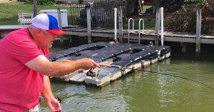Russ Bailey pulls his bait back to prepare to “shoot” his jig underneath a shaded dock. Shooting allows him to get the bait into places a long pole or casting can’t reach. (Photo courtesy Russ Bailey)