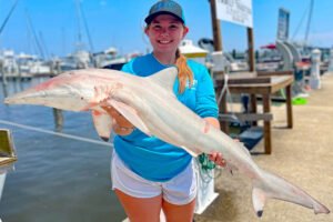 On her first ever shark fishing adventure, Lindsey caught a shark almost as long as she is. She said, “Shark fishing is fun, but for me, it can never beat catching good slabs of crappie.”