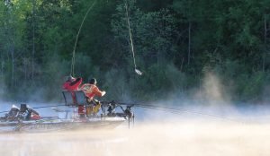 Travis & Charlie Bunting swing a fish to the boat early in the morning during a tournament. Charlies says forward-facing sonar is efficient, but spider rigging is still a great way to catch numbers of fish. Baits can be moved or stopped to trigger bites from sluggish crappie. (Photo: Tim Huffman)