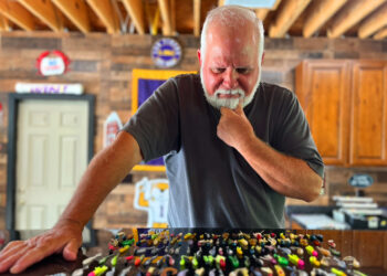 Jim Bates bought over $1,000 worth of lures when he got into crappie fishing. Now he just has to decide which one to use on his next crappie trip. (Photo: Keith Lusher)