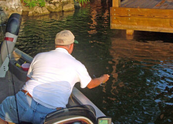 It can take practice to learn how to slingshot a crappie jig beneath a dock that is just a few inches off the water. But perfect the technique and it can be a sure-fire way to connect with crappie in September. (Photo: Richard Simms)