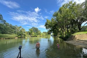 Capt. Richard Simms and his grandson, Charlie, take a dip in the creek and check out the boat ramp while waiting on his son-in-law to arrive to take him to retrieve his truck and tailer for the “broken down” boat. (Photo: Priscilla Simms-Roberson)