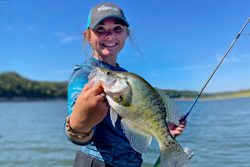 Lindsey Lucas shows off a respectable white crappie. While not extremely distinct, one way to distinguish white crappie from black crappie is the pattern of vertical bars or stripes on the side. Read more to learn about the different types of crappie!