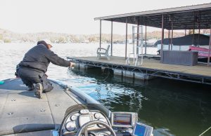 Shooting it where the sun doesn’t shine. Mike Baker shoots jigs under walkways between floatation at Lake of the Ozarks, MO. (Photo: Tim Huffman)