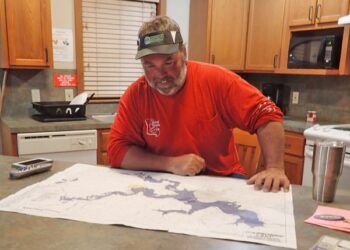 Electronic maps are key for on-the-water searching, but paper maps are still good tools for studying the lake while relaxing in your cabin.