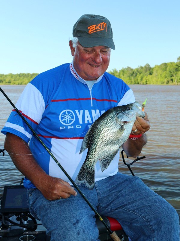 Dannenmueller with a good crappie taken from a submerged brush. Mixing the right area + contour change + cover = crappie.