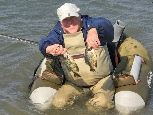 Bill Hartman displays two crappies he caught on back-to-back casts while fly fishing on a farm pond.