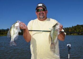 Joe Dunn shows off a couple crappie he caught while fishing on Millers Ferry Reservoir near Millers Ferry, AL.