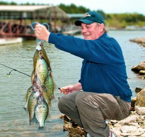 Author Mike Gnatkowski with a mixed-bag stringer of black and white crappies. They might not be number one on the list for many, or most, Michigan anglers… but maybe they should be. Michigan Spring Crappie
